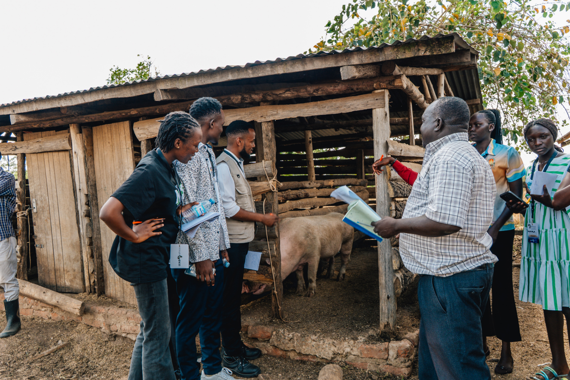Tukutuku team conducting field research with community members at a local farm